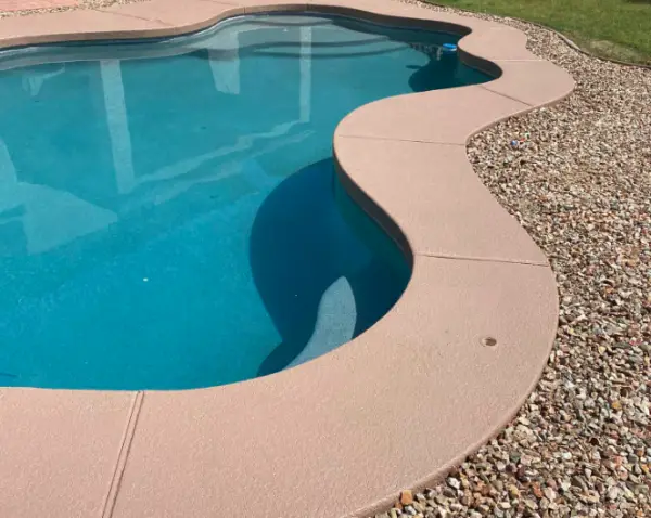 Refinished pool deck beside blue swimming pool in Phoenix